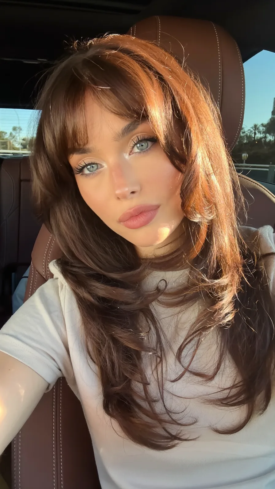 Voluminous Long Layers with Curtain Bangs and Feathered Ends