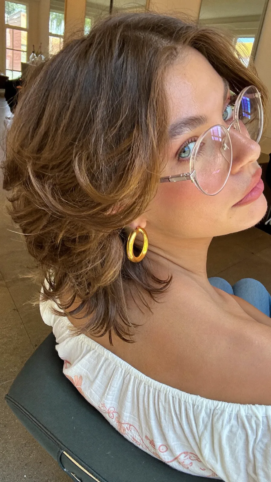 Voluminous Shoulder-Length Layered Hairstyle with Curtain Bangs