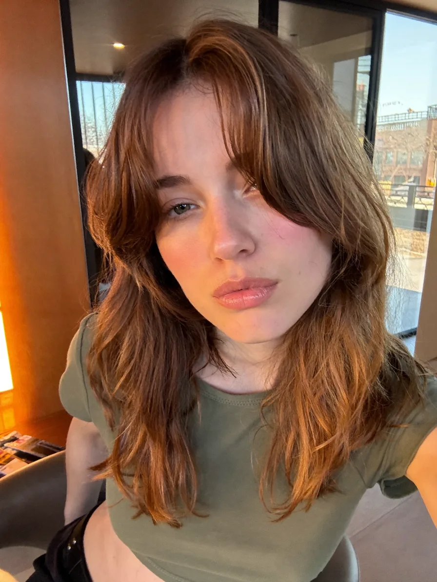 Medium-Length Wavy Hair with Curtain Bangs and Long Layers