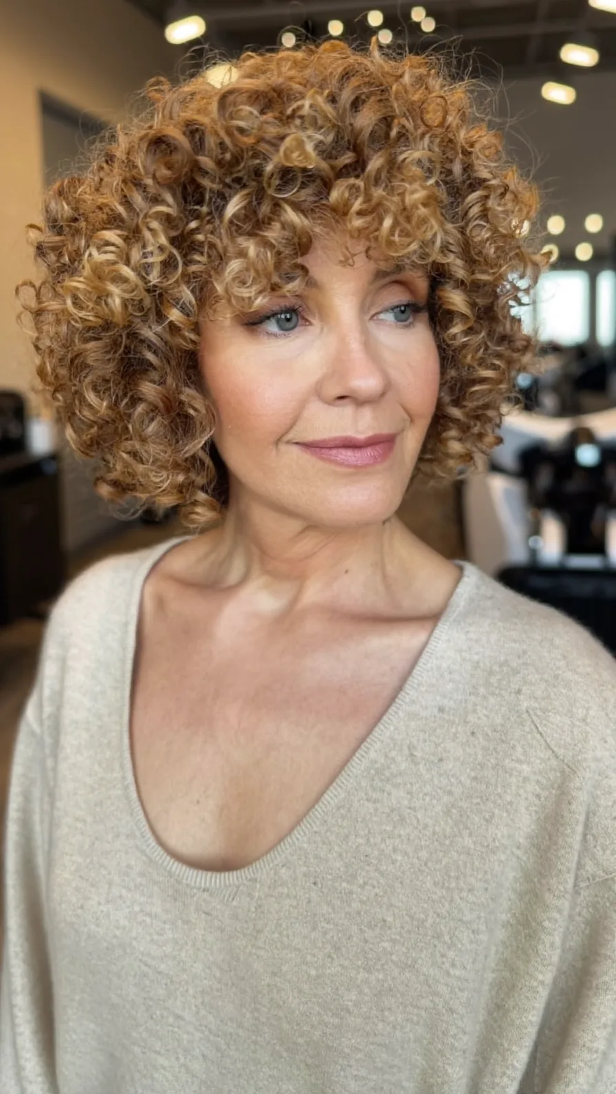 Chin-Length Voluminous Curly Bob with Golden Highlights