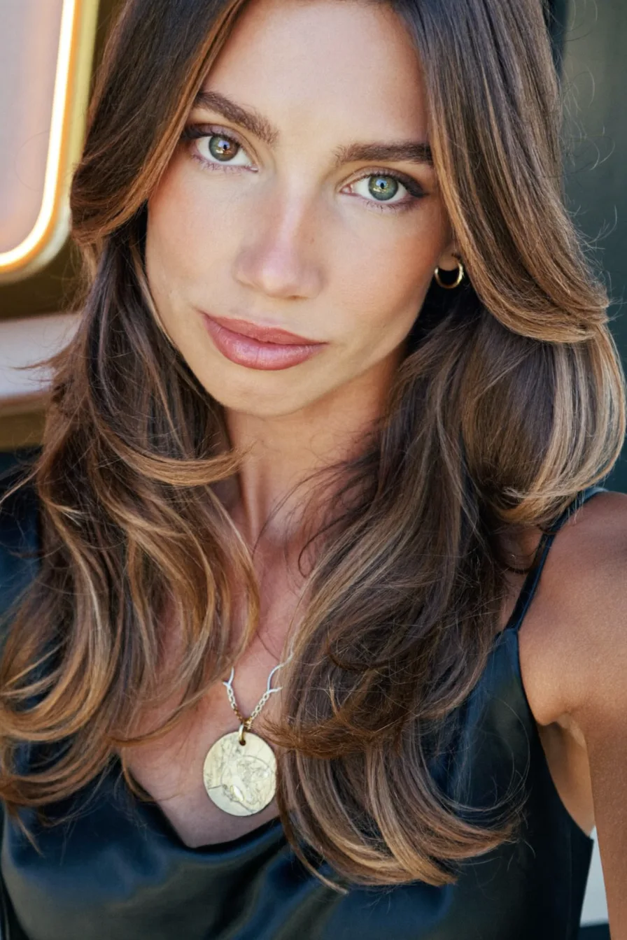Elegant Long Layered Hair with Soft Curtain Bangs and Balayage