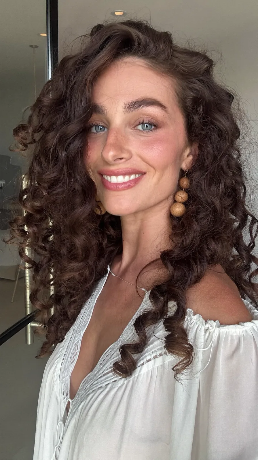 Voluminous Rich Brown Long Layered Curly Hairstyle