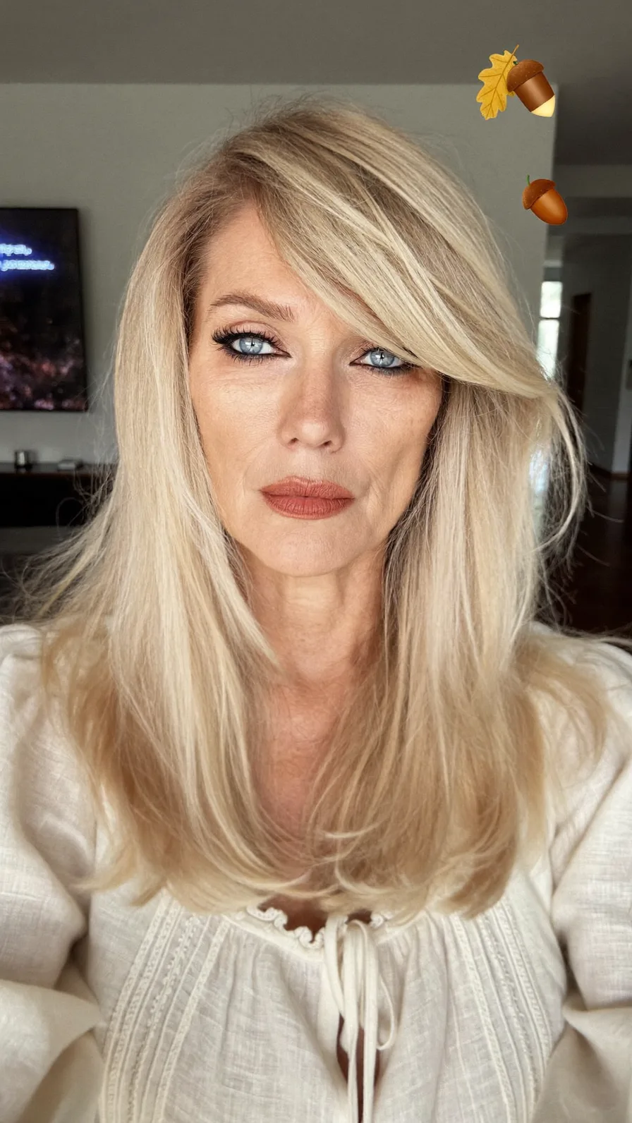 Elegant Long Layered Blonde Hairstyle with Side-Swept Bangs