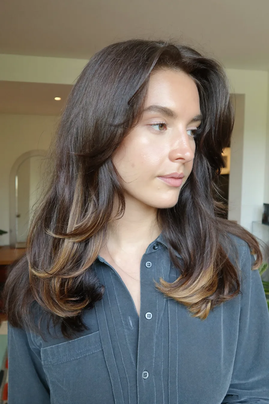 Chic Layered Charcoal Brunette with Sun-Kissed Accents