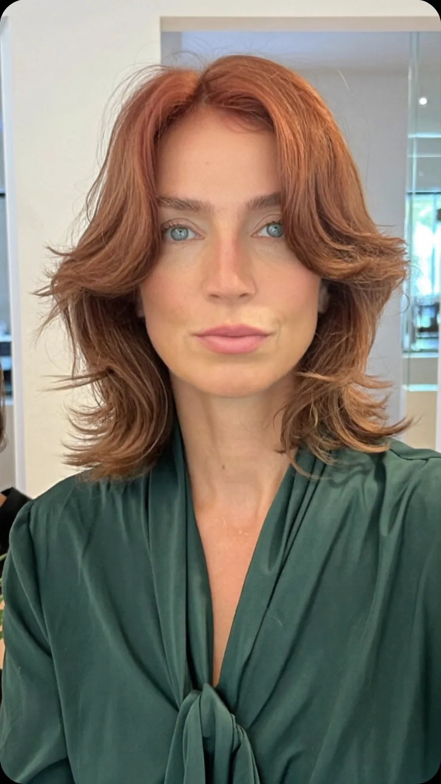 Soft Feathered Shoulder-Length Copper Auburn Hairstyle