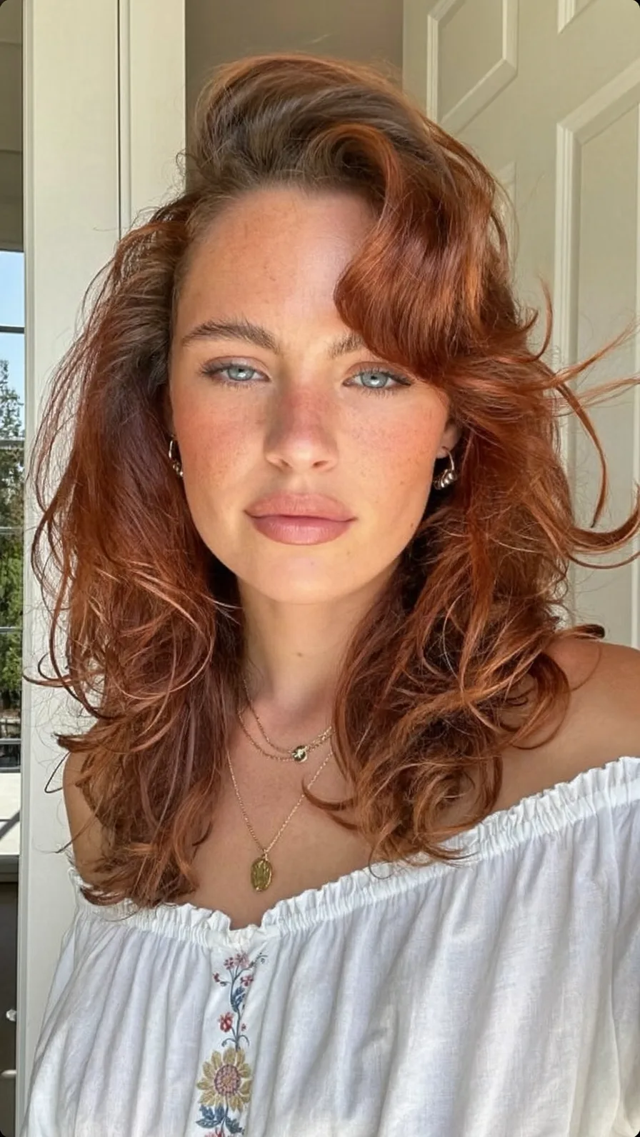 Voluminous Copper Auburn Wavy Long Layers with Side-Swept Bangs
