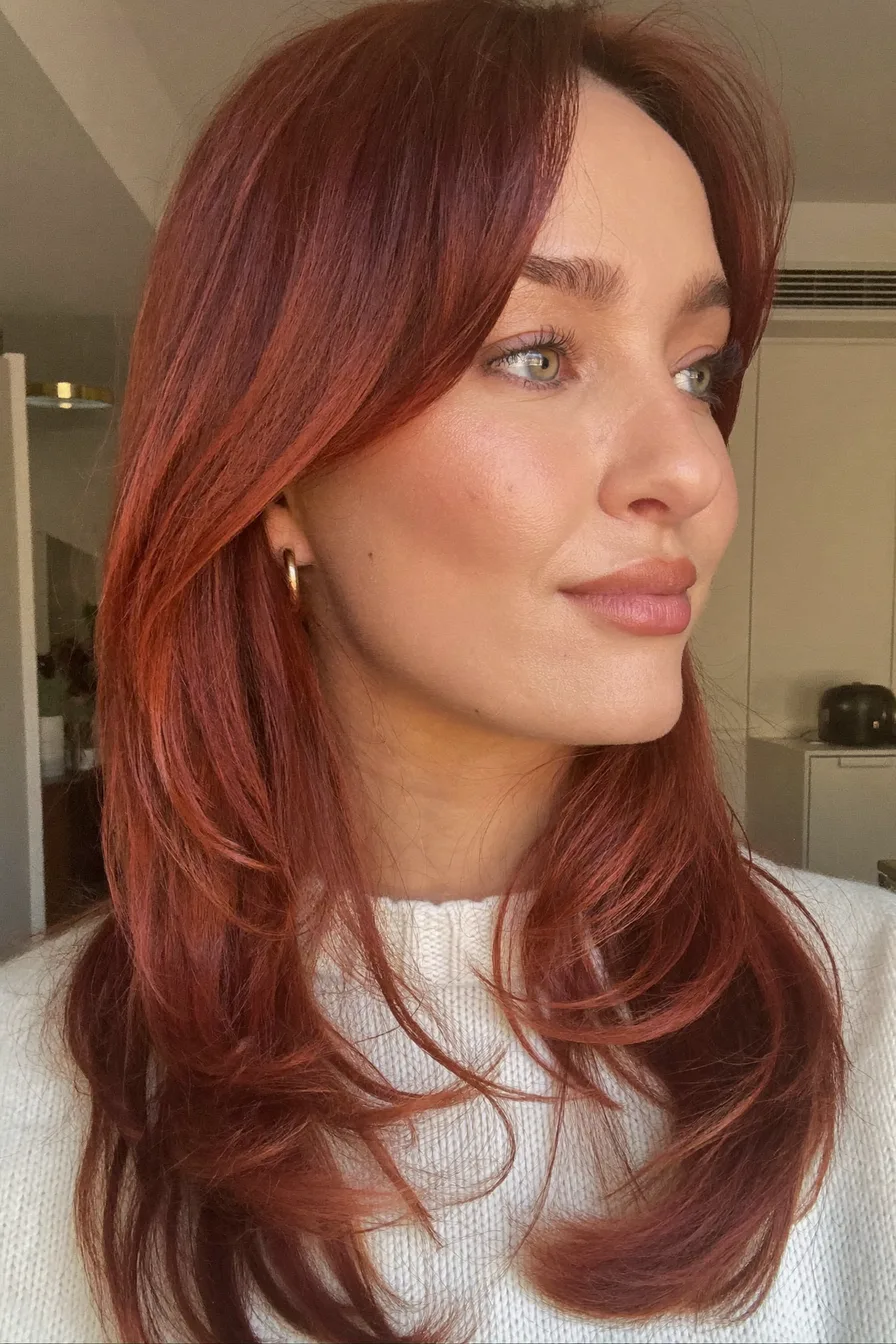 Layered Cowgirl Copper Hairstyle with Effortless Face-Framing Bangs