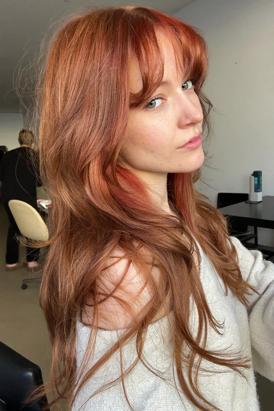 Long Layered Cowgirl Copper Hairstyle with Face-Framing Bangs