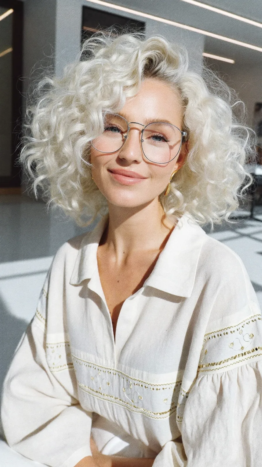 Voluminous Platinum Blonde Curly Bob with Side-Swept Bangs