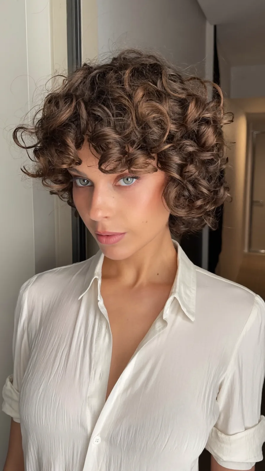 Voluminous Curly Bob with Rounded Ends and Curtain Bangs