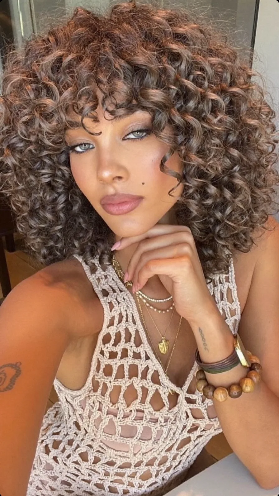 Voluminous Curly Bob with Subtle Highlighted Bangs Style