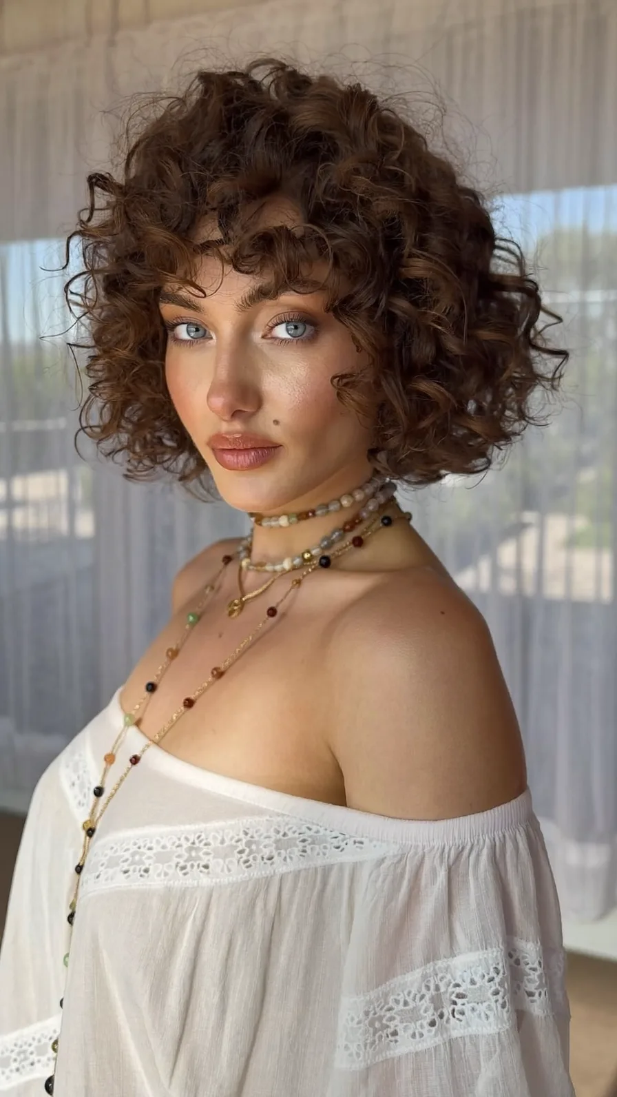 Voluminous Curly Bob with Rounded Ends and Curly Bangs