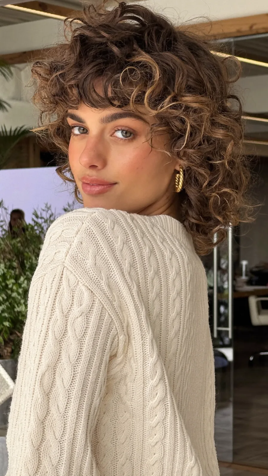 Voluminous Curly Bob with Bouncy Curtain Bangs and Balayage Highlights