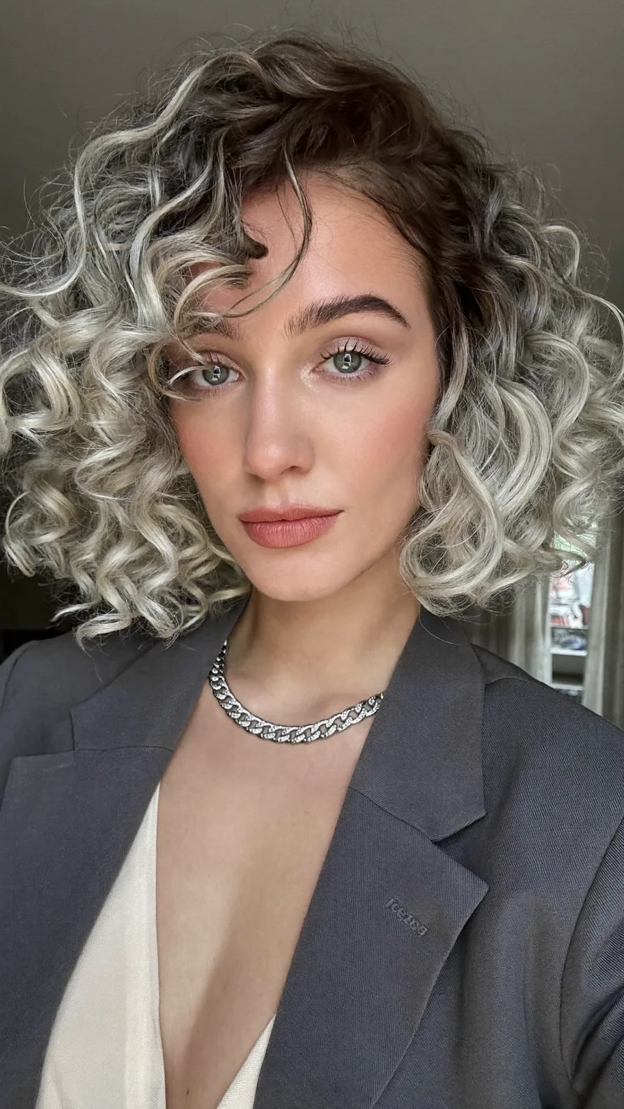 Modern Curly Bob with Ashy Silver Balayage and Deep Side Part