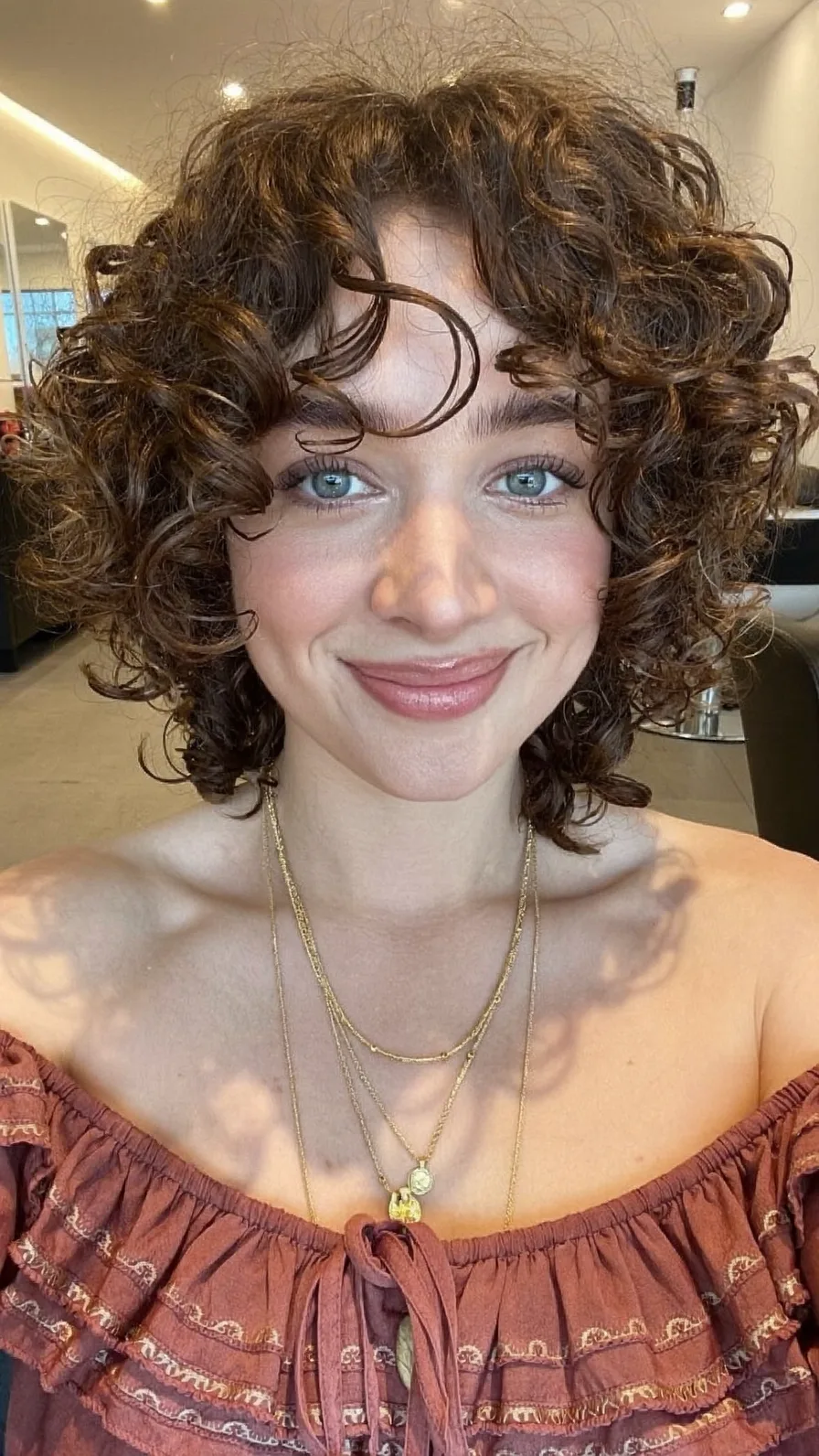 Voluminous Curly Bob with Curtain Bangs and Choppy Layers