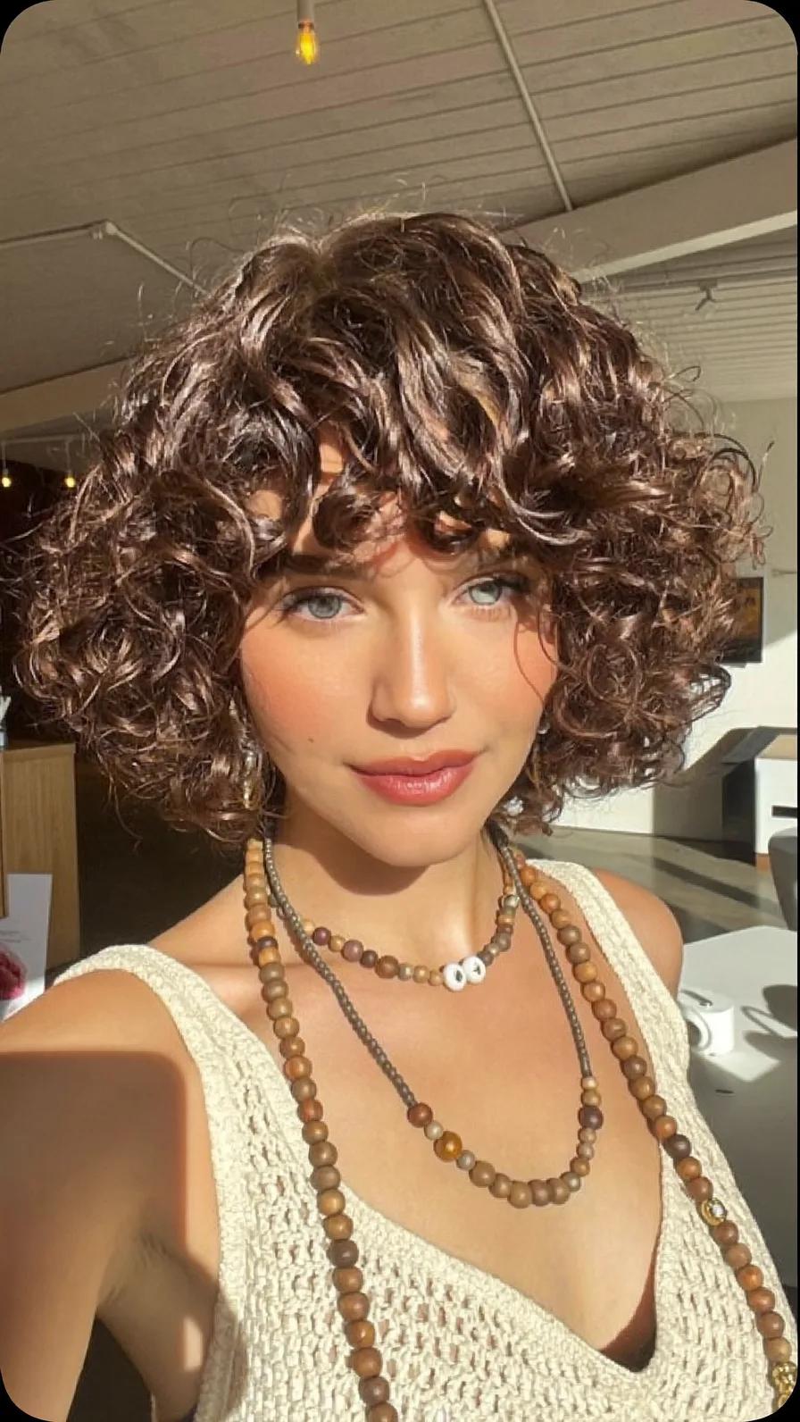 Voluminous Curly Choppy Bob with Subtle Warm Highlights