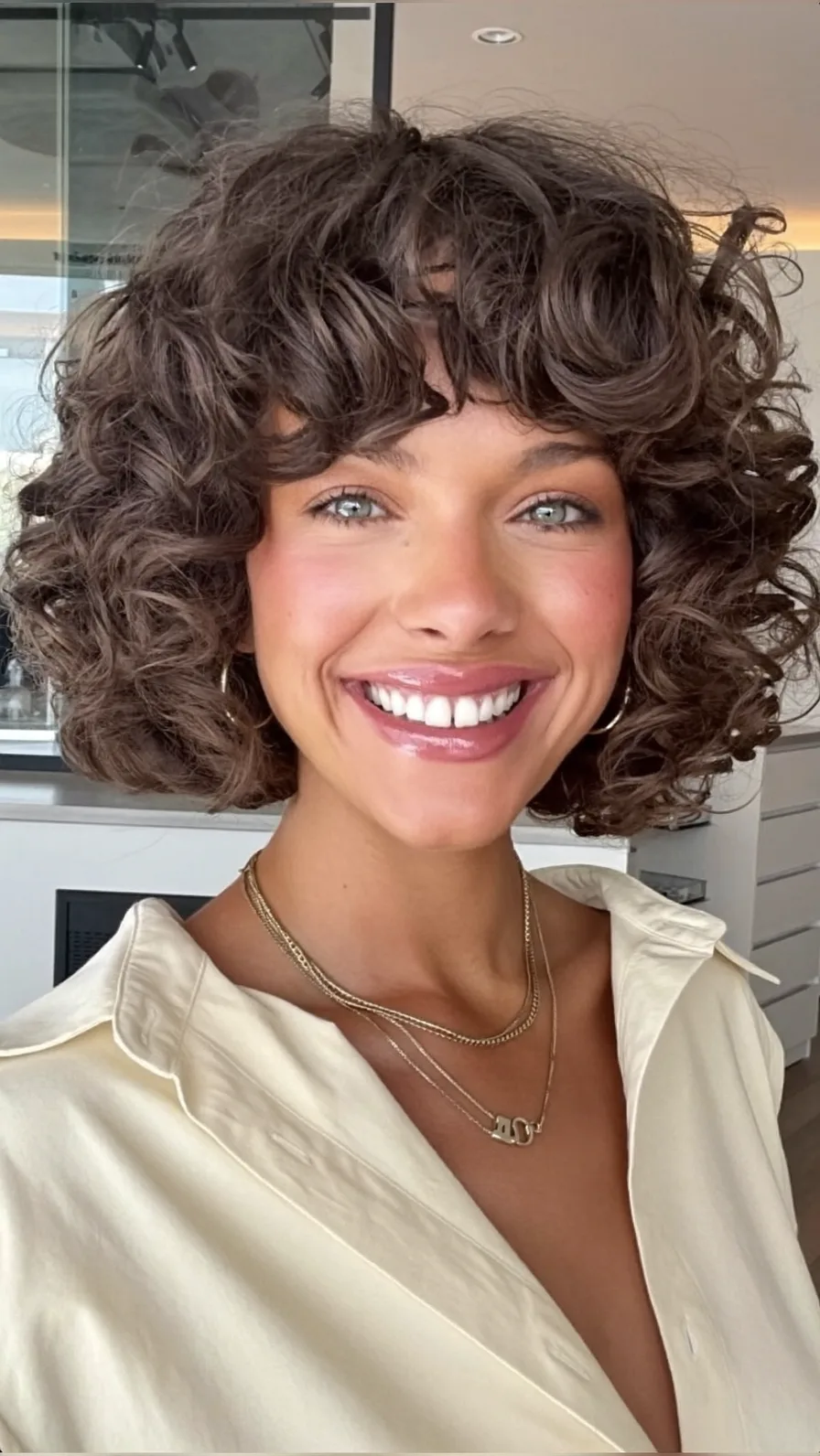 Voluminous Curly Bob with Soft Curtain Bangs Style