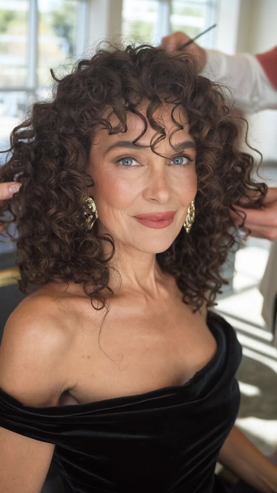 Voluminous Curly Layered Hairstyle with Soft Curtain Bangs