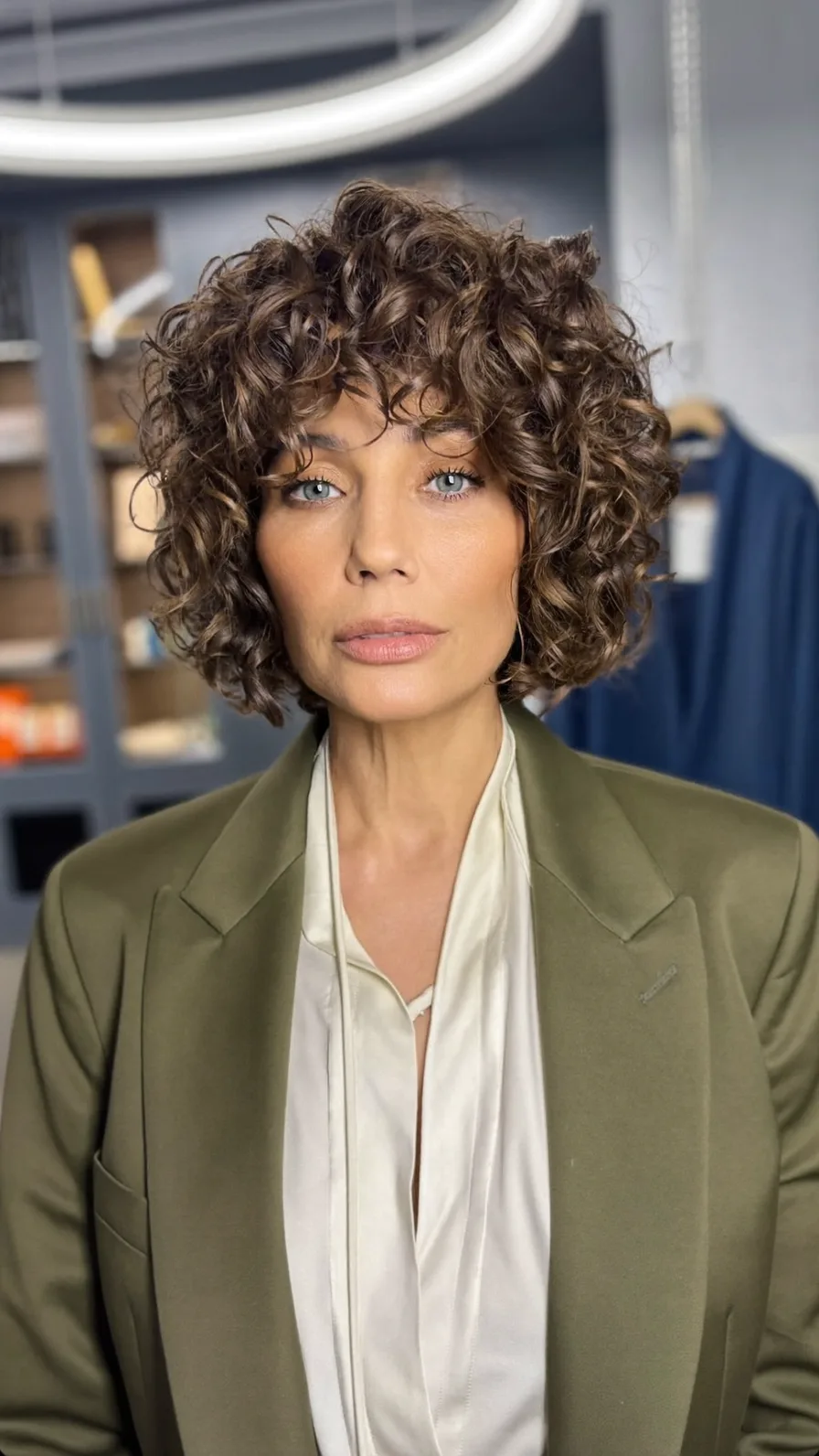 Voluminous Curly Bob with Curtain Bangs for Oval Faces