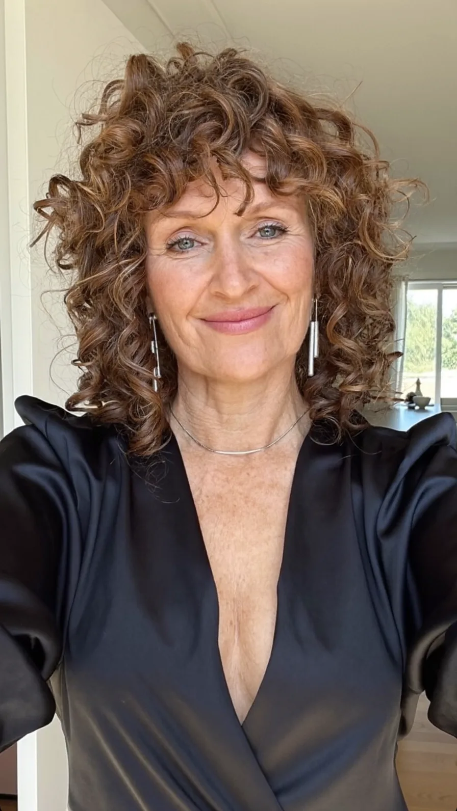 Voluminous Layered Curly Bob with Curtain Bangs