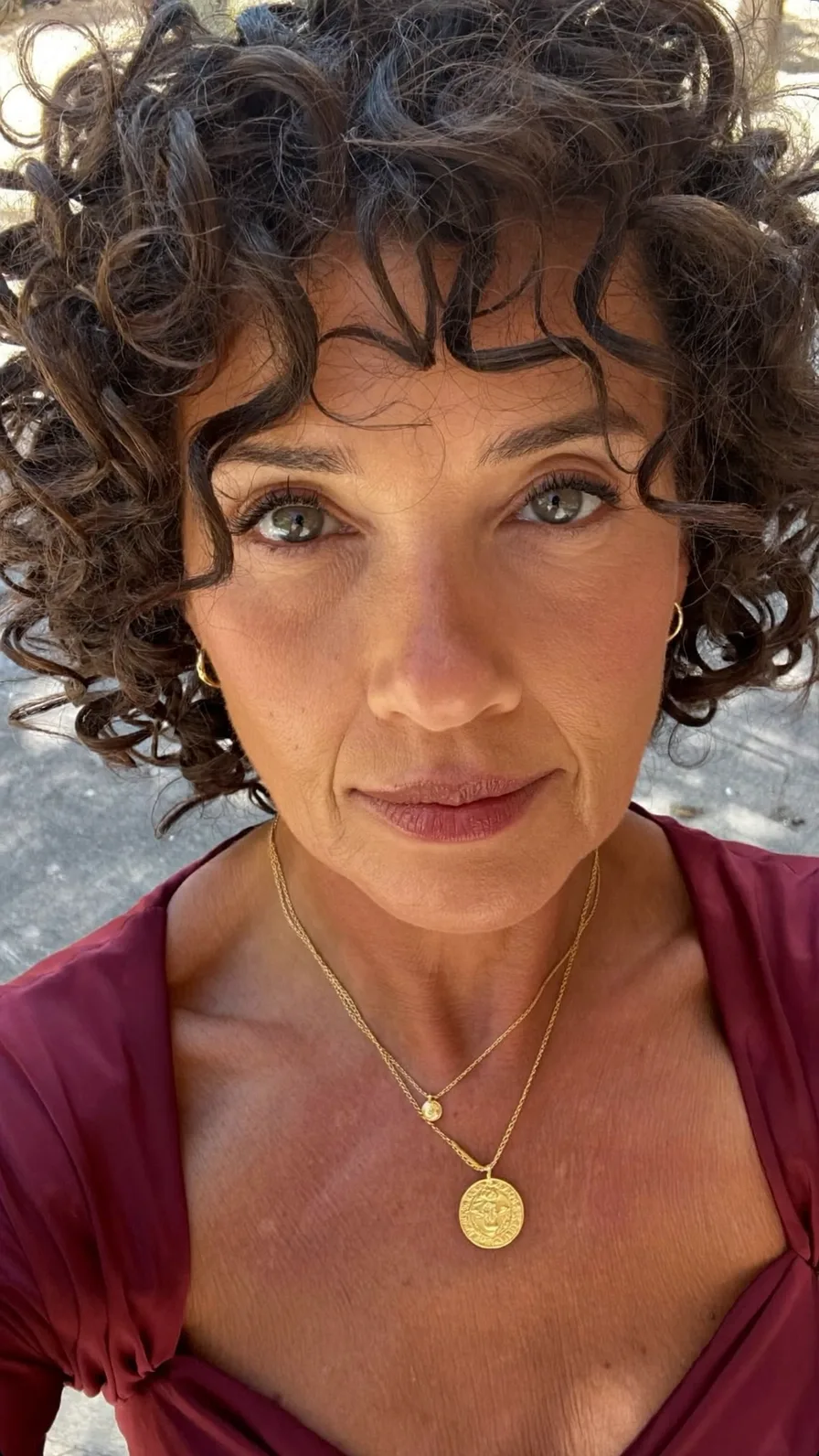 Voluminous Curly Bob with Soft Curtain Bangs for Mature Hair