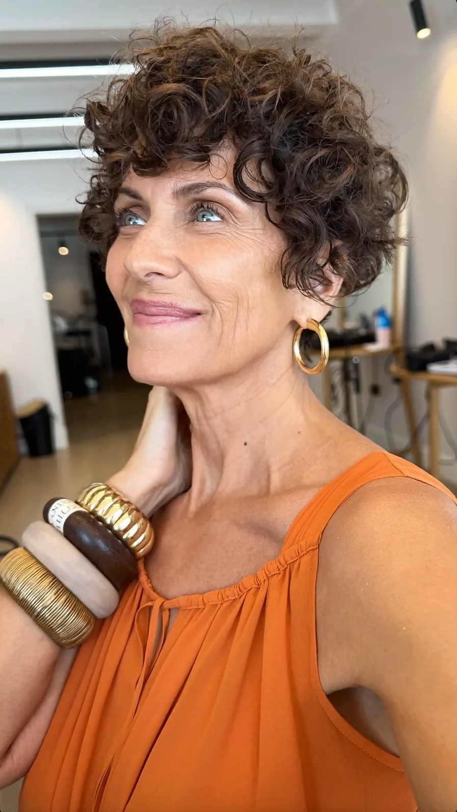 Voluminous Short Curly Layers with Soft Curtain Bangs