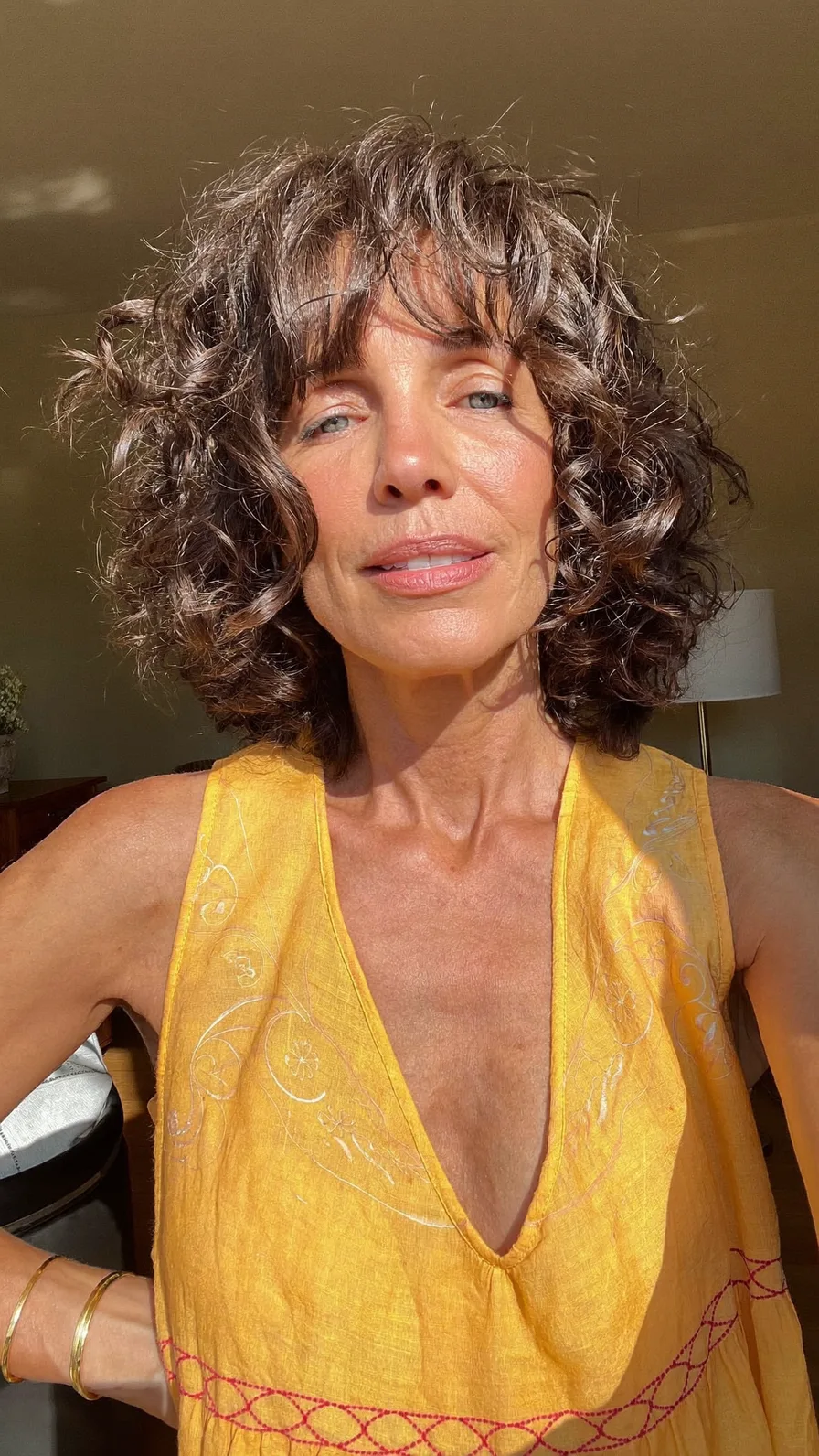 Voluminous Curly Chin-Length Layered Hair with Curtain Bangs