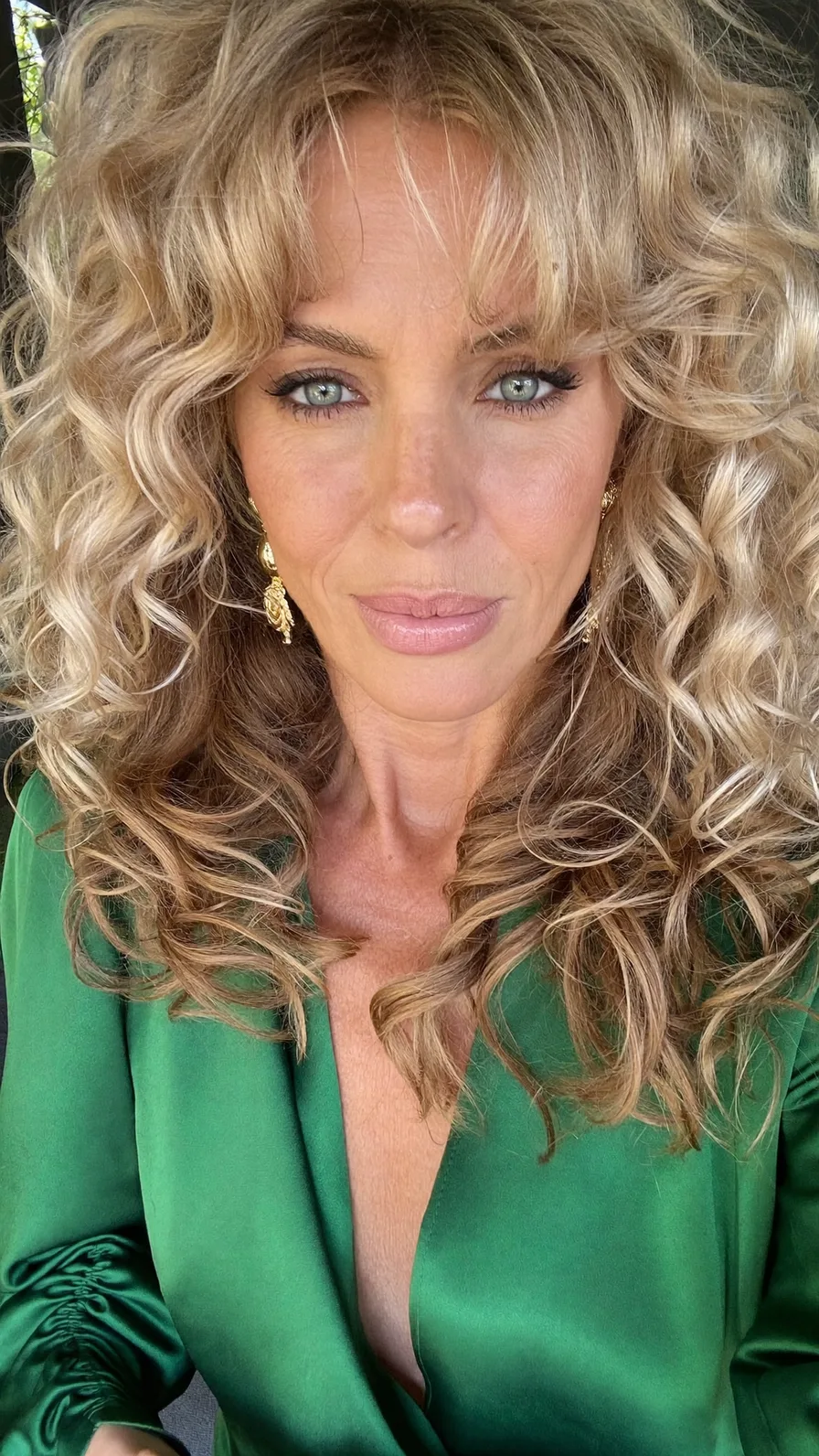Voluminous Layered Curls With Curtain Bangs For Added Softness