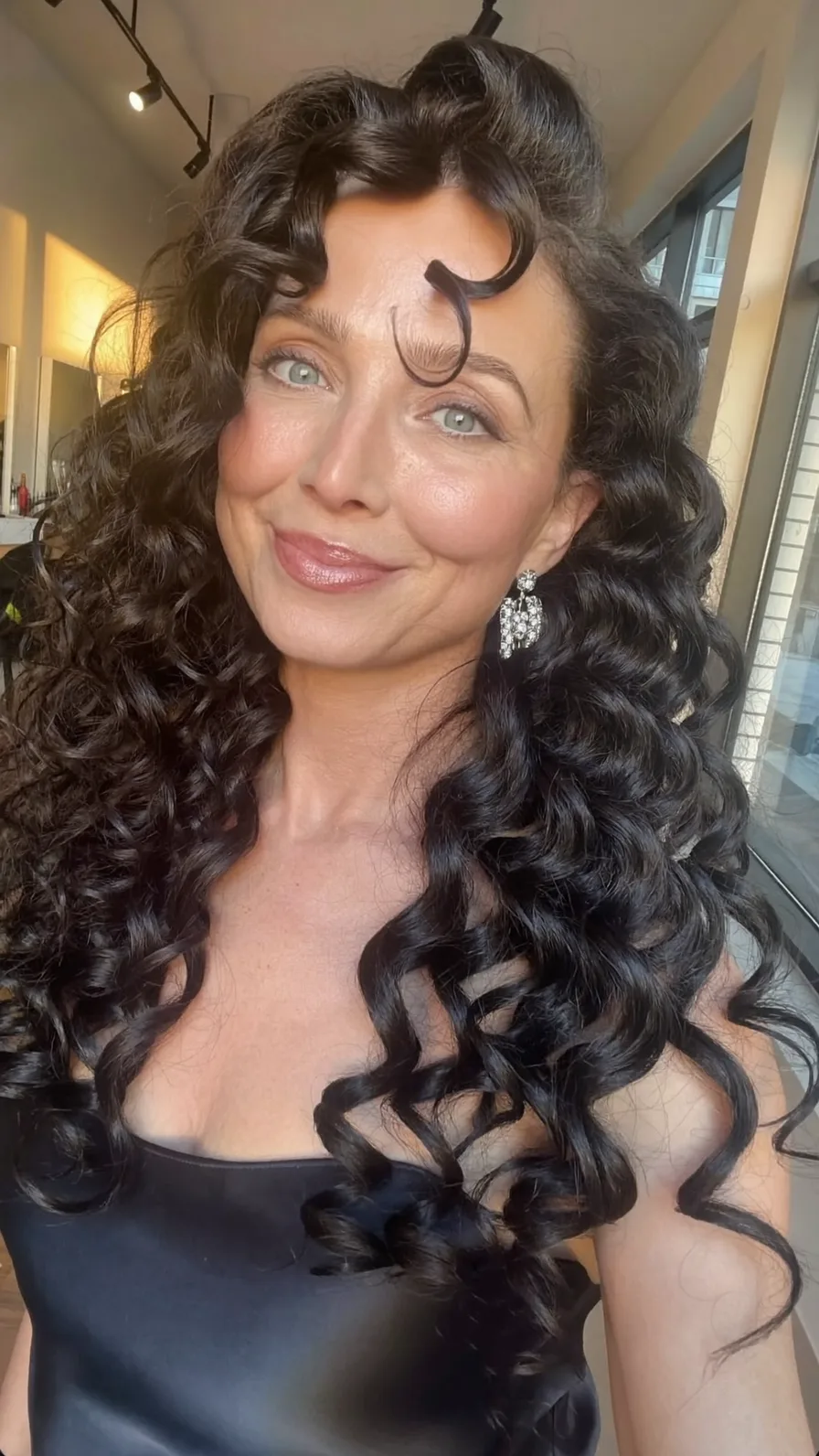 Voluminous Long Layers with Curtain Bangs for Curly Hair