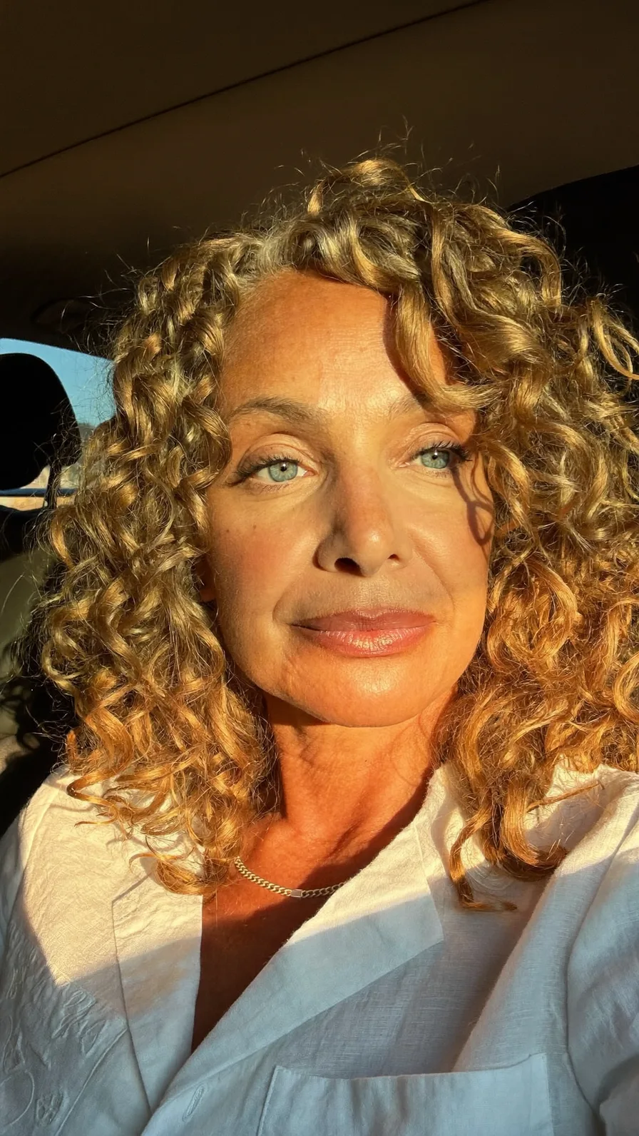 Voluminous Curly Shoulder-Length Honey Blonde Long Layers