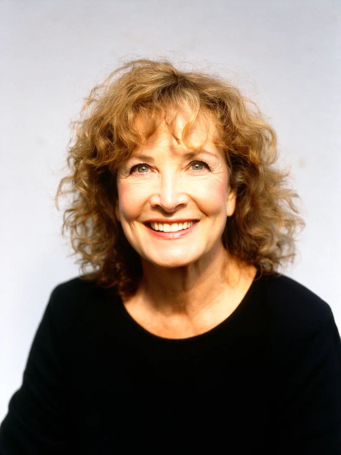 Medium Warm Caramel Brown Curly Layers with Wispy Bangs