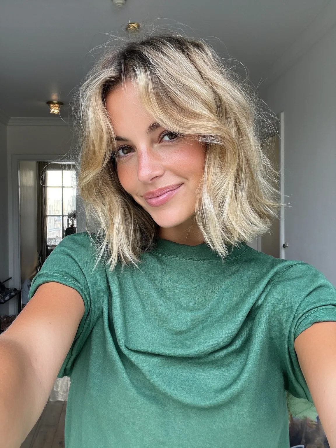 Voluminous Wavy Sun-Kissed Blonde Bob with Curtain Bangs