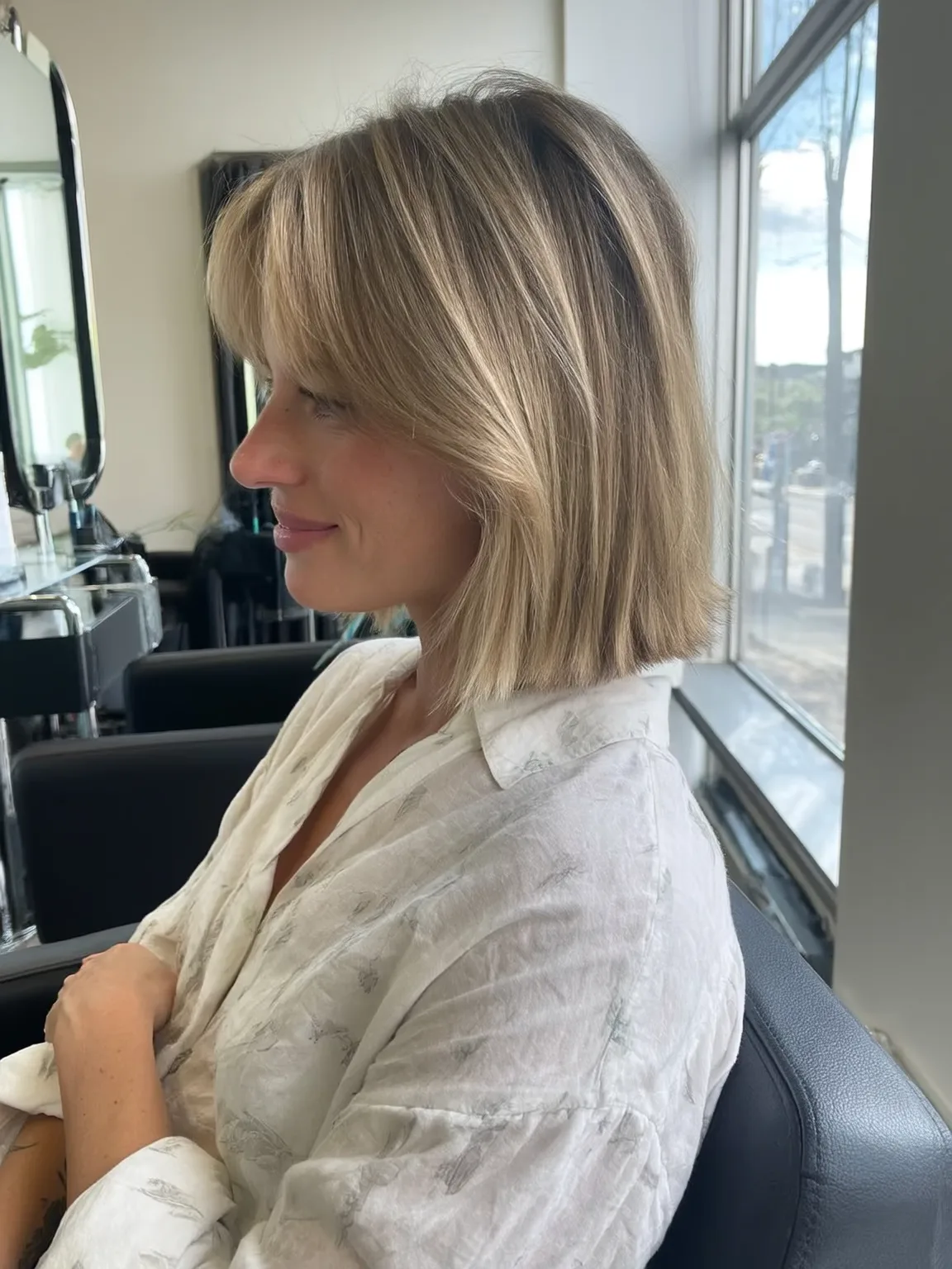 Sandy Blonde Straight Bob with Curtain Bangs and Medium Volume