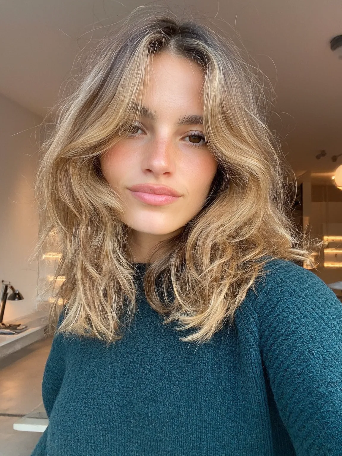 Voluminous Sandy Blonde Shoulder-Length Layers with Honey Highlights
