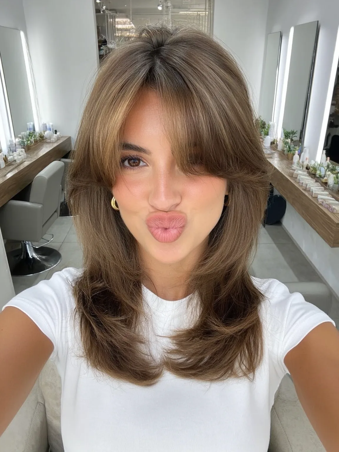 Medium Voluminous Warm Caramel Brown Wavy Layers with Curtain Bangs