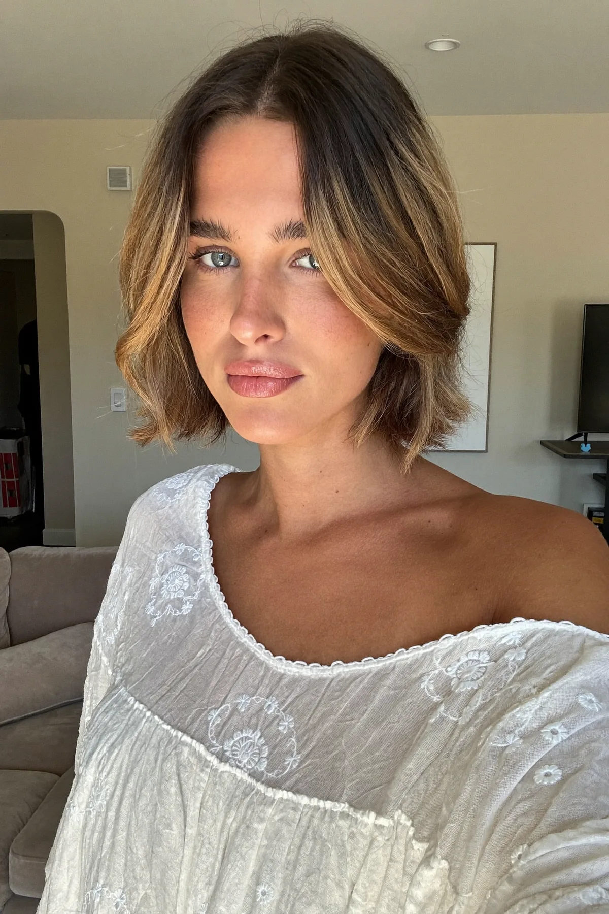 Chin-Length Dark Blonde Bob with Wavy Texture and Curtain Bangs