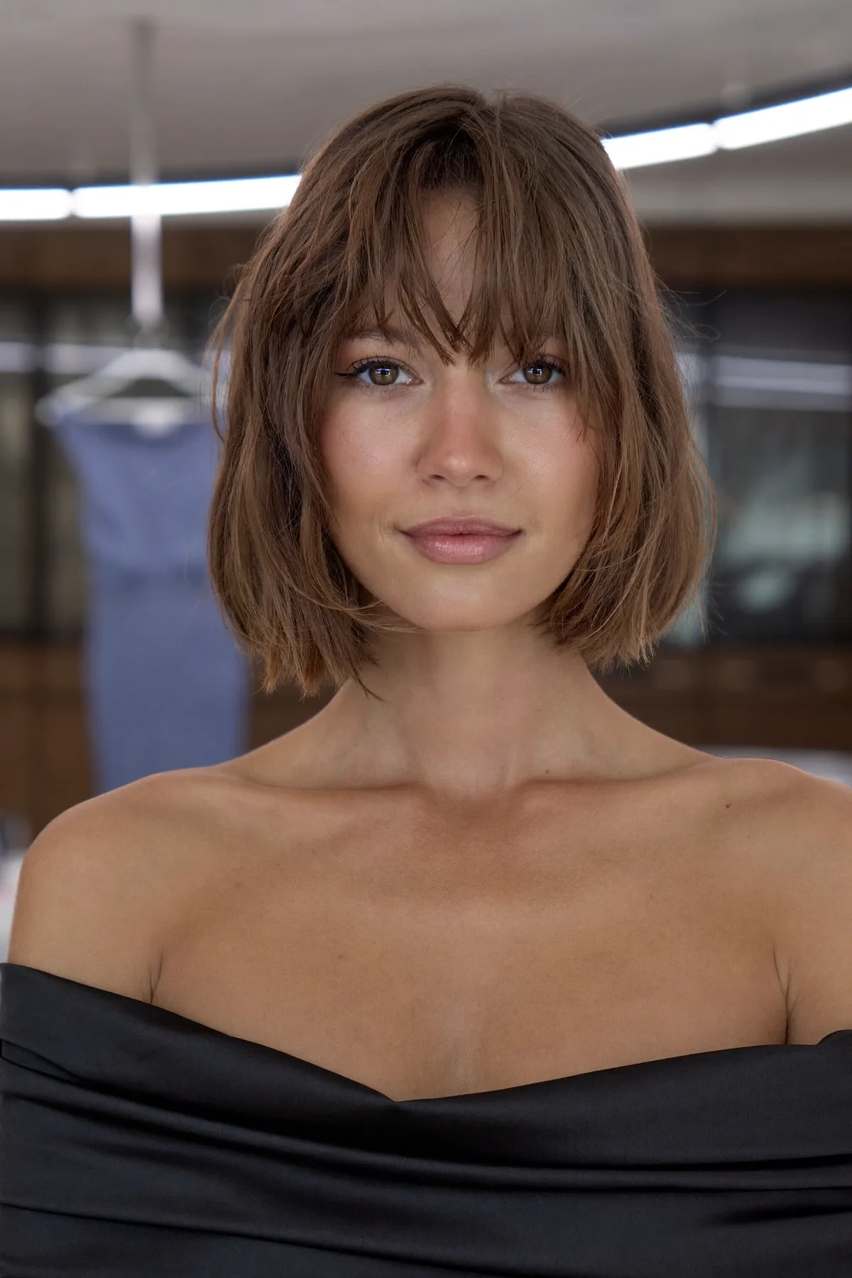 Chin-Length Dark Blonde Bob with Wavy Texture and Curtain Bangs