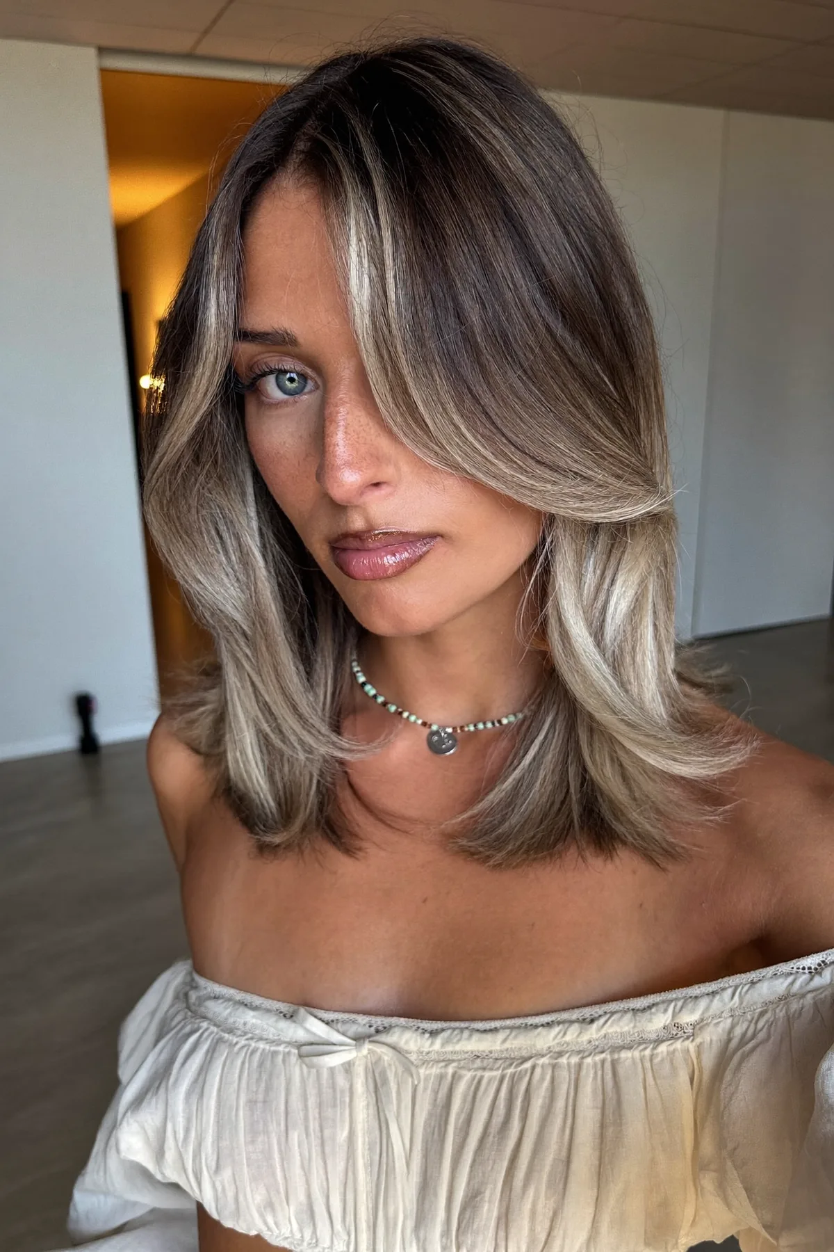 Sleek Straight Dark Blonde Lob with Curtain Bangs and Balayage