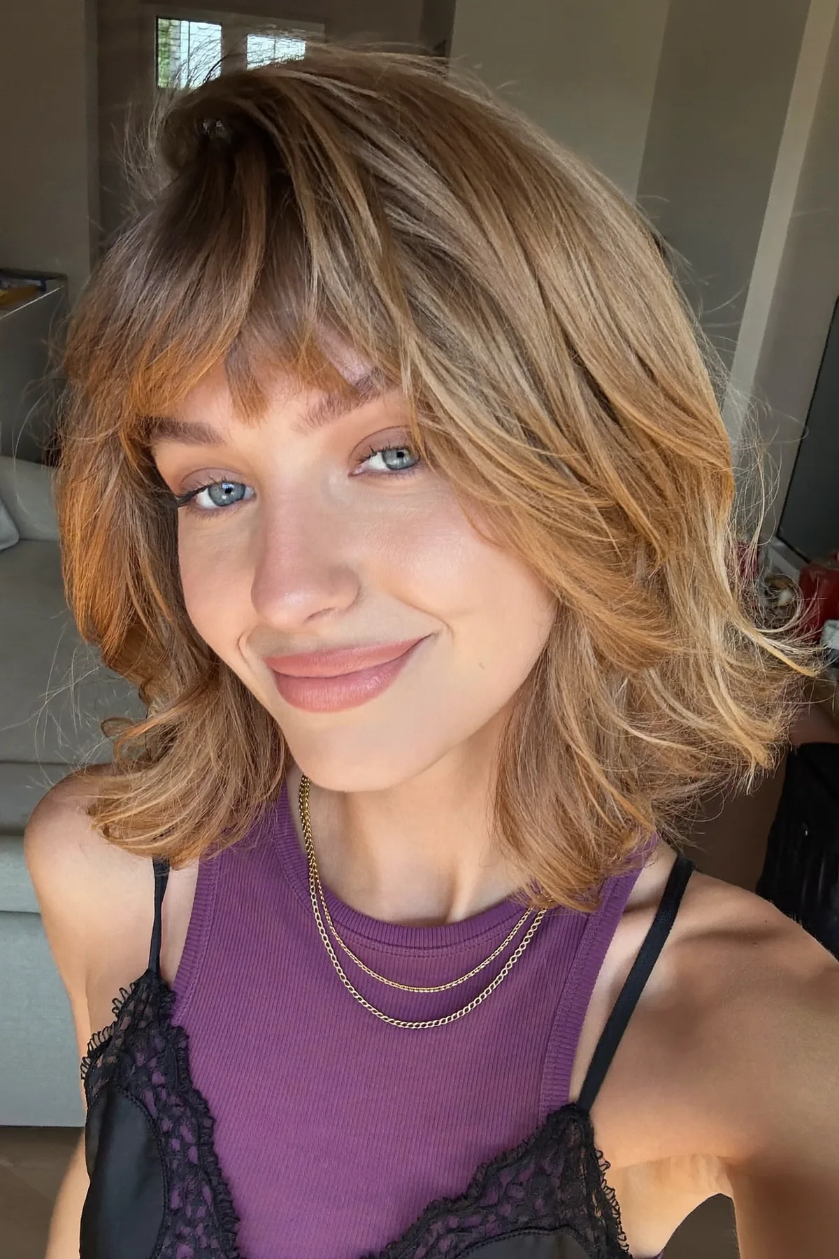Effortless Dark Blonde Shoulder-Length Shag with Full Fringe Bangs