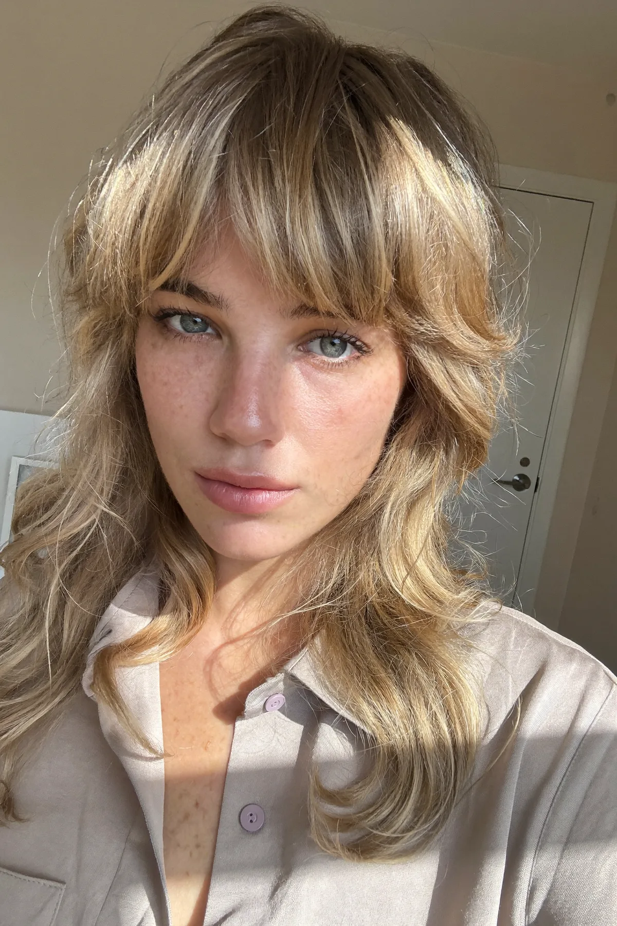 Radiant Dark Blonde Wavy Lob with Curtain Bangs