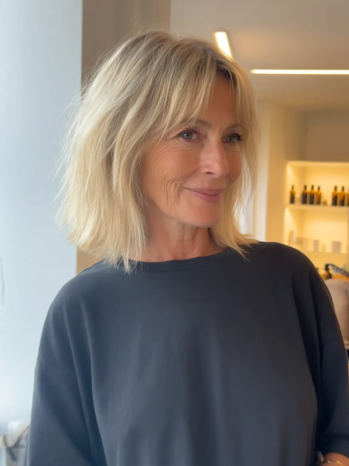Wavy Sandy Blonde Lob with Curtain Bangs and Versatile Length