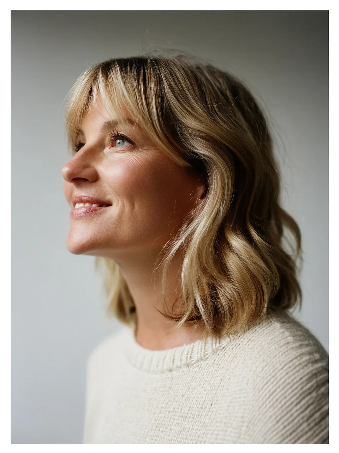 Shoulder-Length Lob with Curtain Bangs in Sandy Blonde