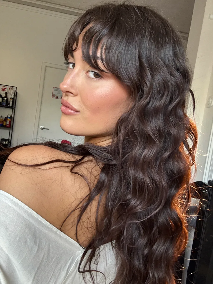 Flowing Long Layers with Soft Curtain Bangs for Wavy Hair