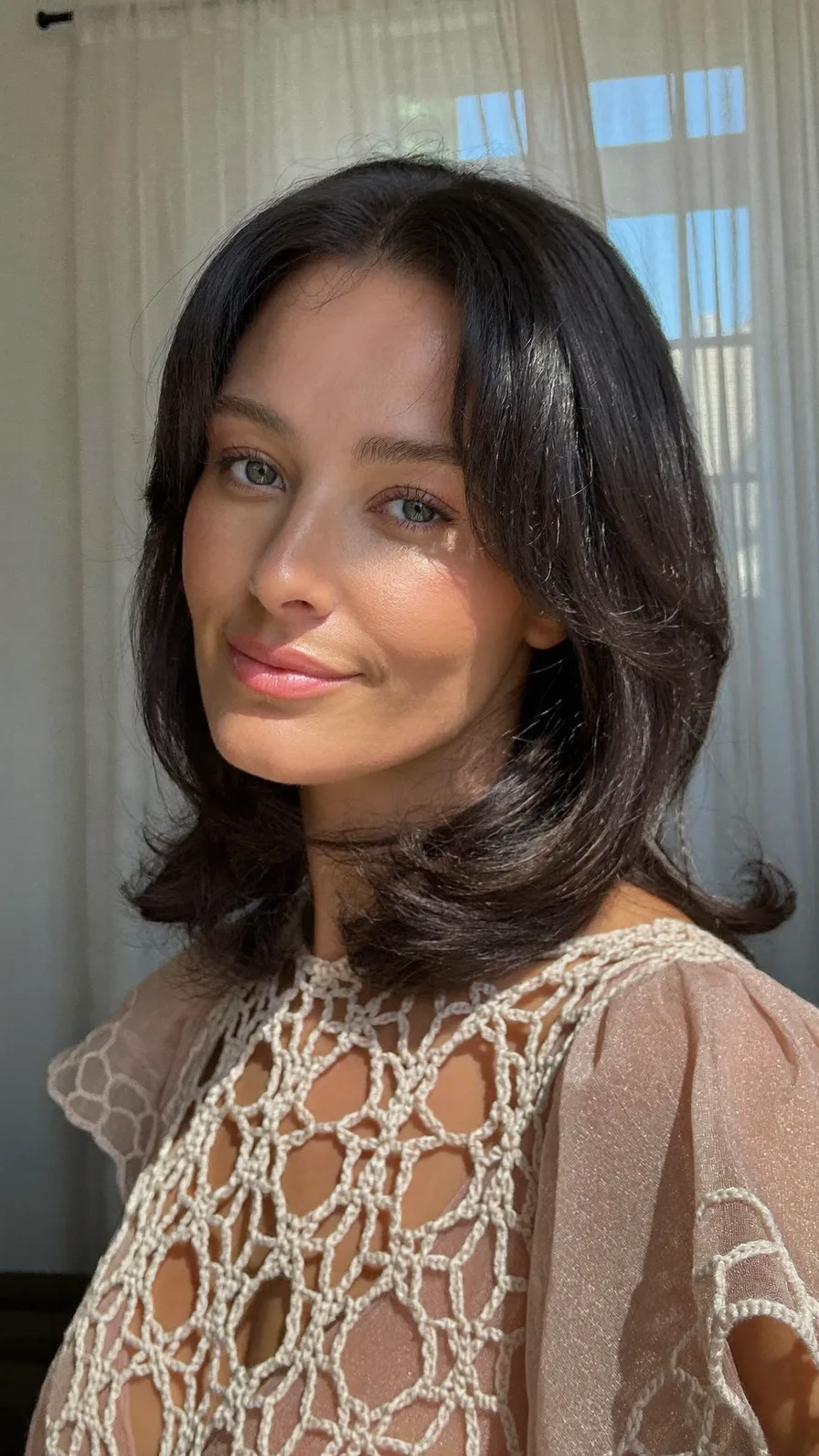 Elegant Shoulder-Length Long Layers with Curtain Bangs and Flicked Ends