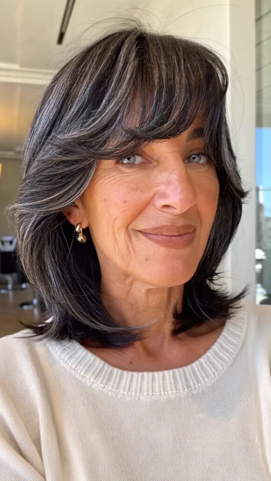 Shoulder-Length Layered Hair with Feathered Curtain Bangs