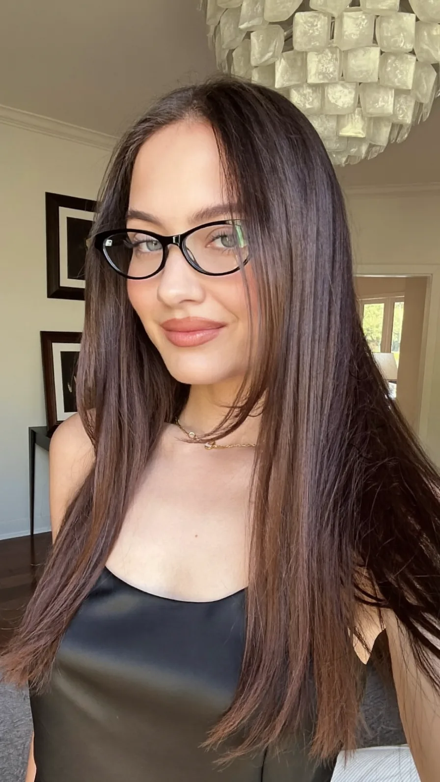 Sleek Long Layered Hair with Center Part and Subtle Bangs
