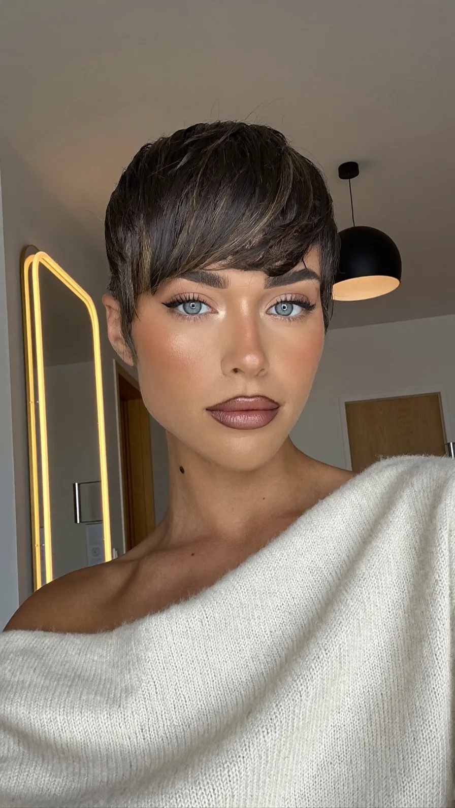 Textured Side-Swept Pixie Cut with Warm Brown Highlights
