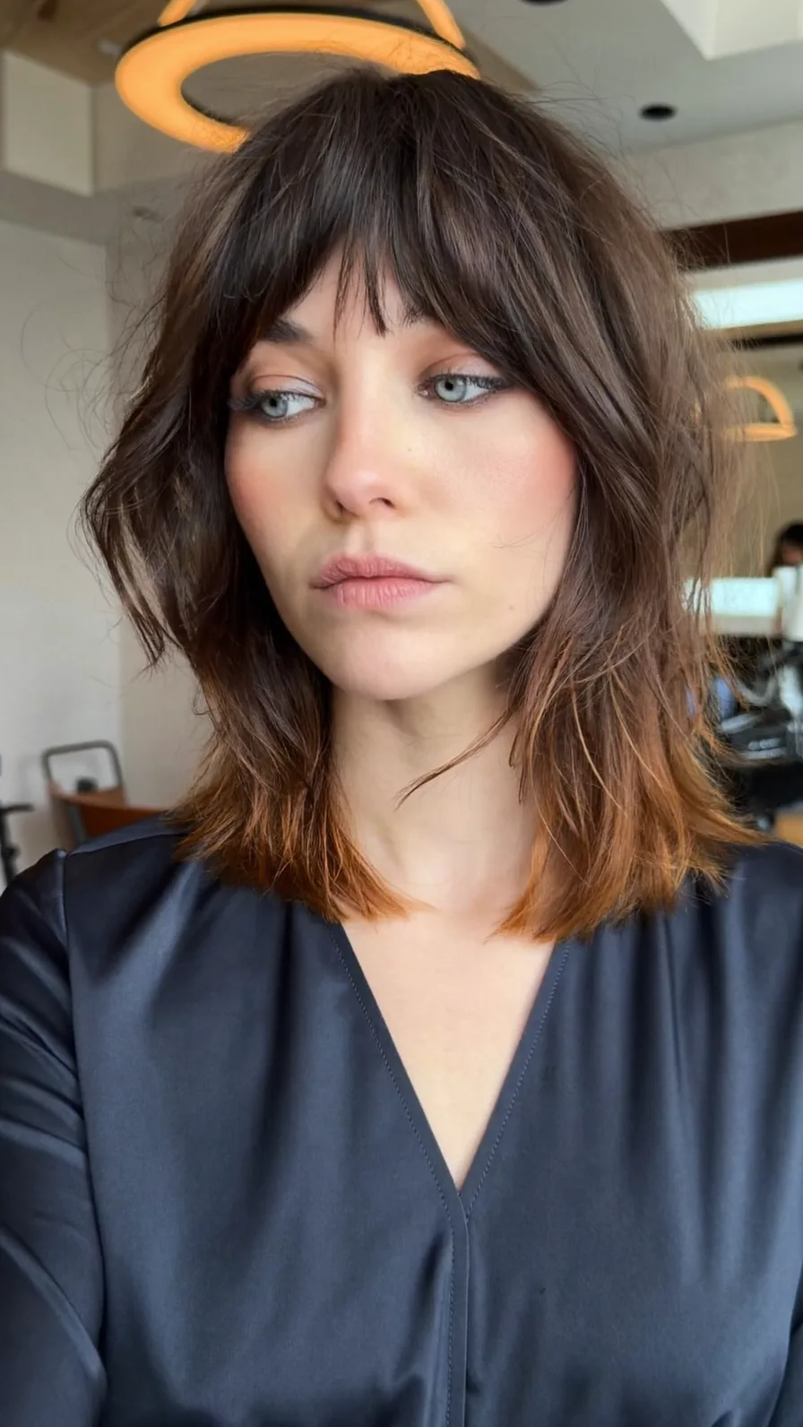 Modern Shaggy Shoulder-Length Haircut with Wispy Bangs