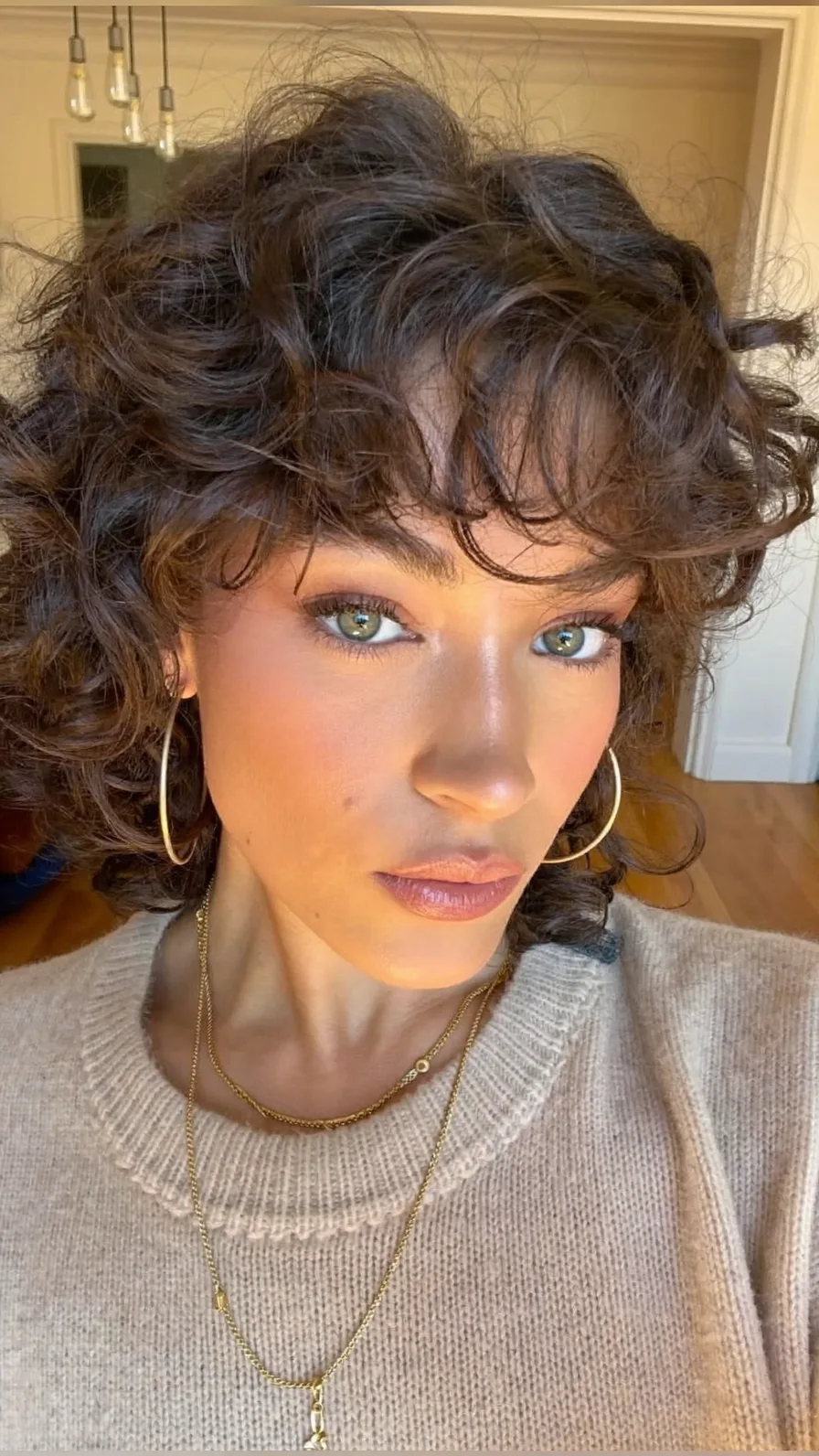 Voluminous Curly Shag with Wispy Bangs and Choppy Layers