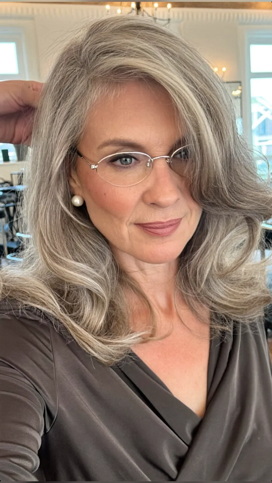 Elegant Silver Ash Gray Medium Length Layered Hairstyle for Mature Women